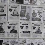 Candidates put posters on the walls of buildings in Jahangirnagar University ahead of student union votes --